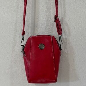 Red Leather Crossbody Bag with Decorative Medallion
